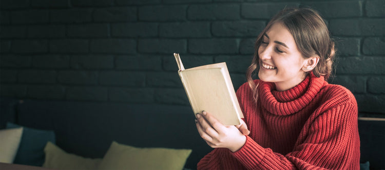 Girl reading a book about creating wealth.